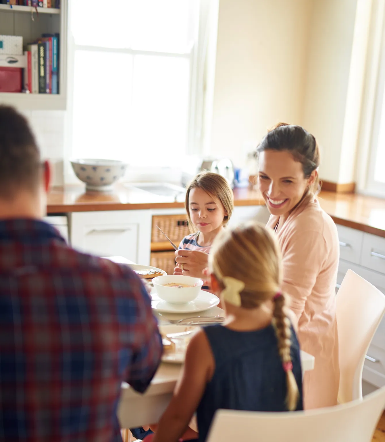 Famille de quatre qui mange à table pendant la campagne des élections 2026