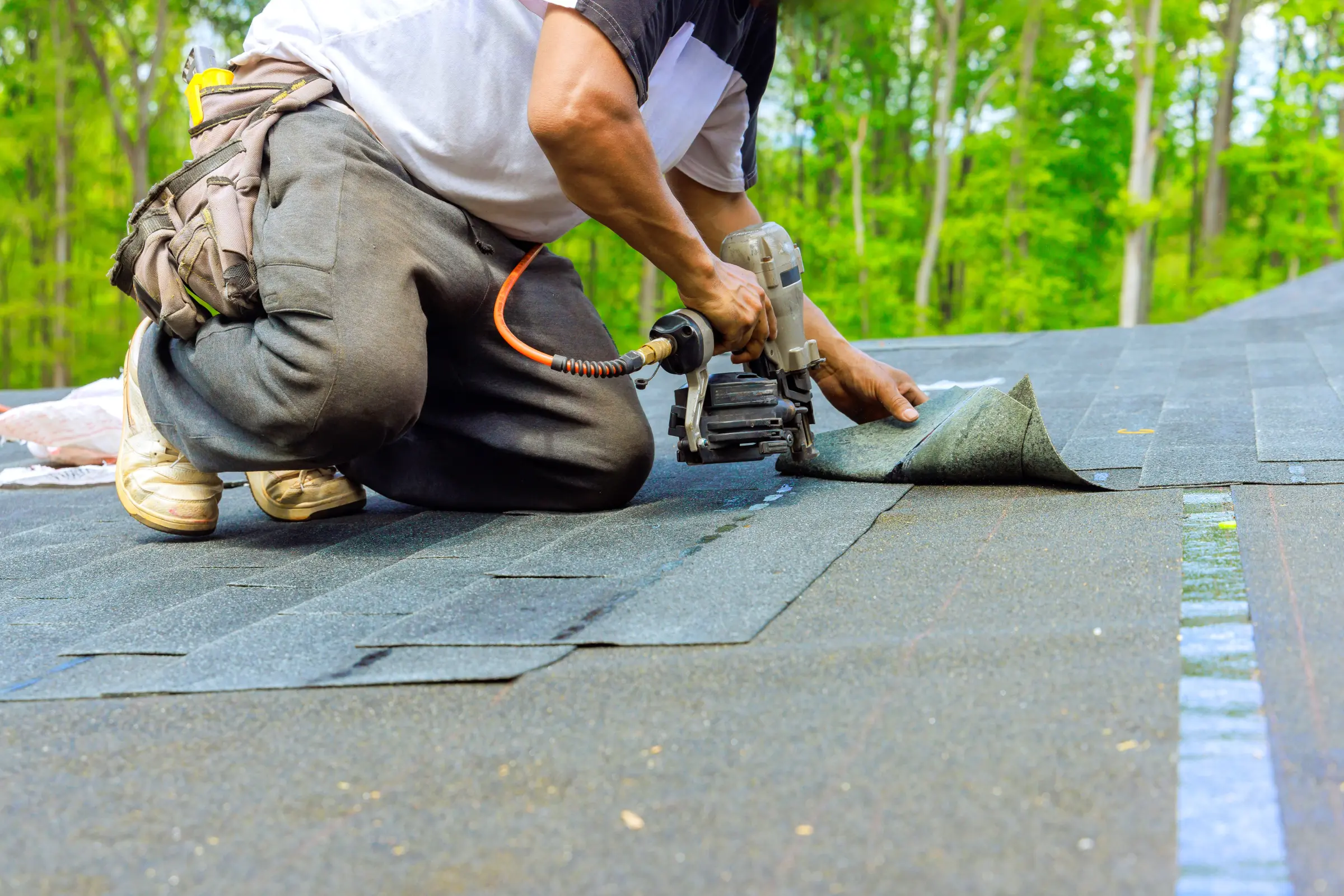 Worker repairing the roof of an aging plex