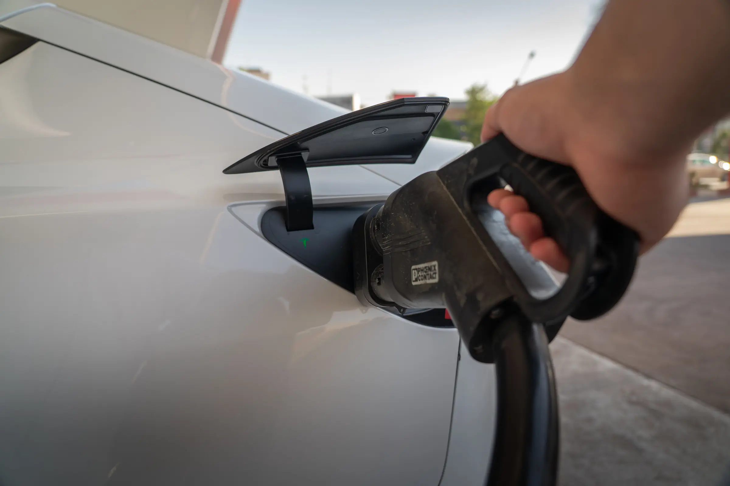 Person who charges their car at an electric charging station